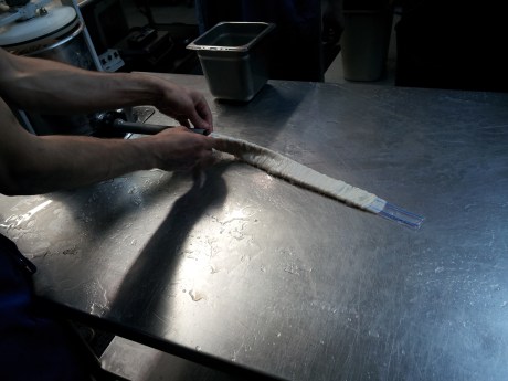 This is a pork casing going on the "horn" that feeds the product into the casing. 