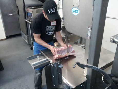 Band sawing pork chops into shape. 